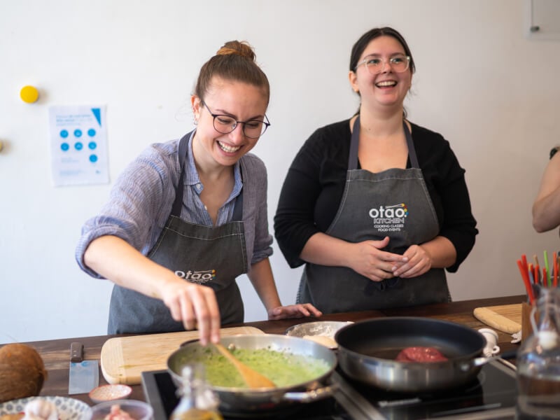 women laughing at cooking class